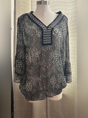 Evolution by JMS black and gray animal print blouse featuring a V-neckline